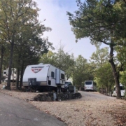 Level gravel RV site with full hook-ups at Branson Shenanigans RV Park