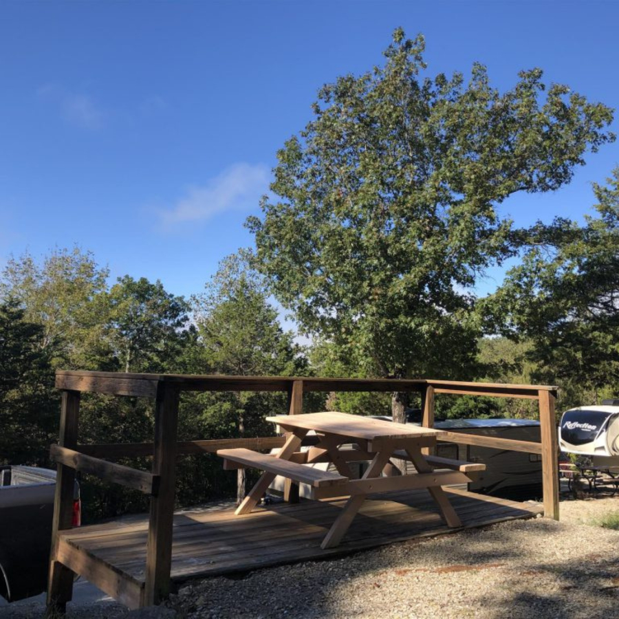 Terraced RV site surrounded by trees at Branson Shenanigans RV Park