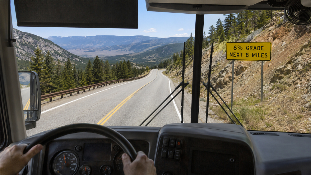 Motorhome descending a winding mountain pass at a controlled speed
